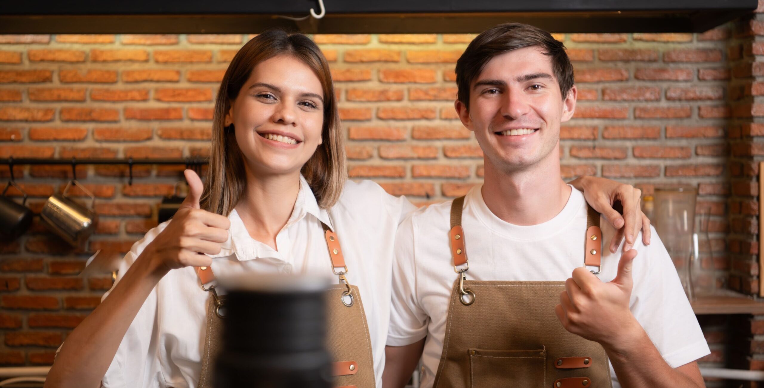 portrait-of-a-young-male-and-female-barista-in-a-c-2023-11-27-05-35-30-utc (1)